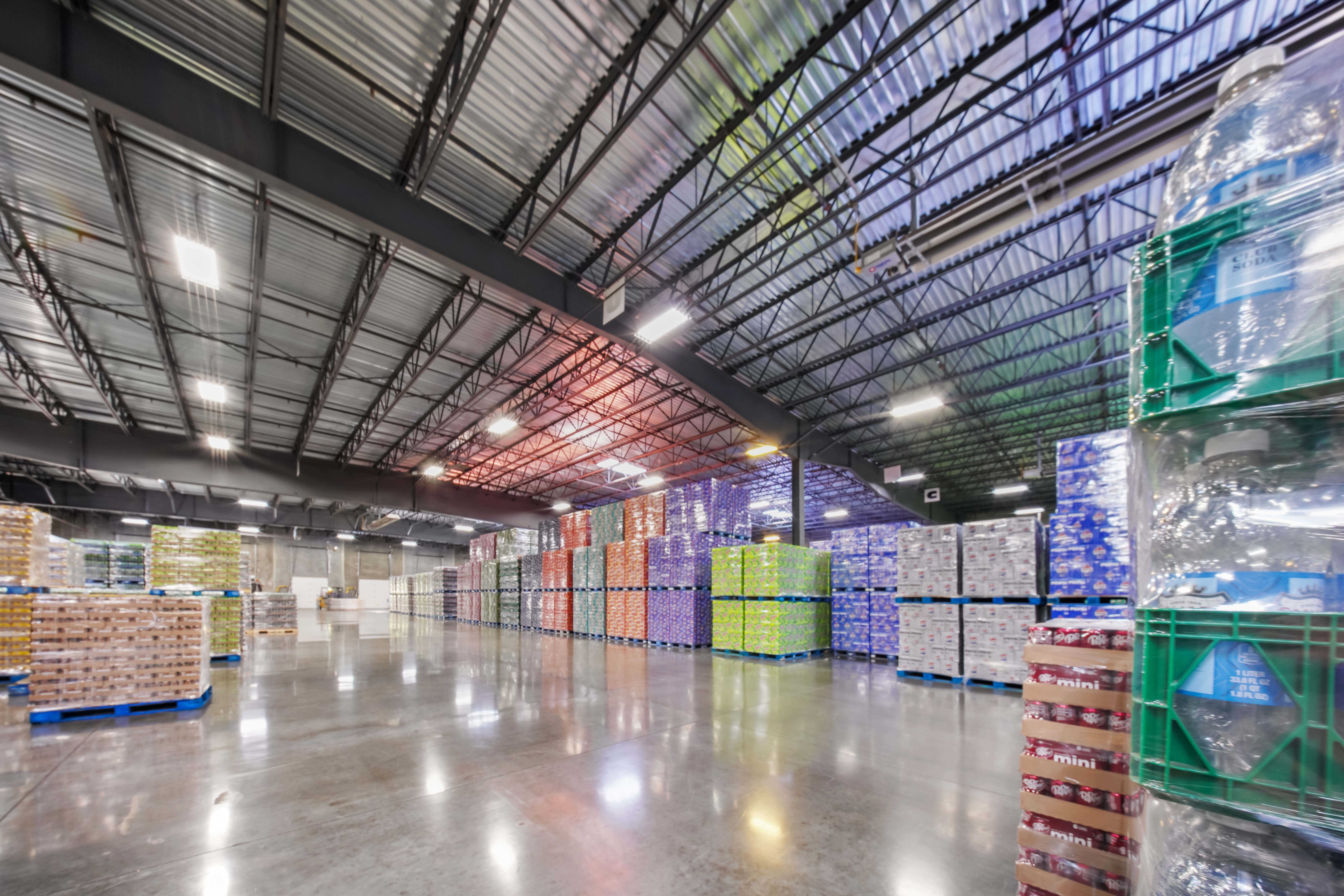 Cans and bottles packaged and stacked on pallets in warehouse