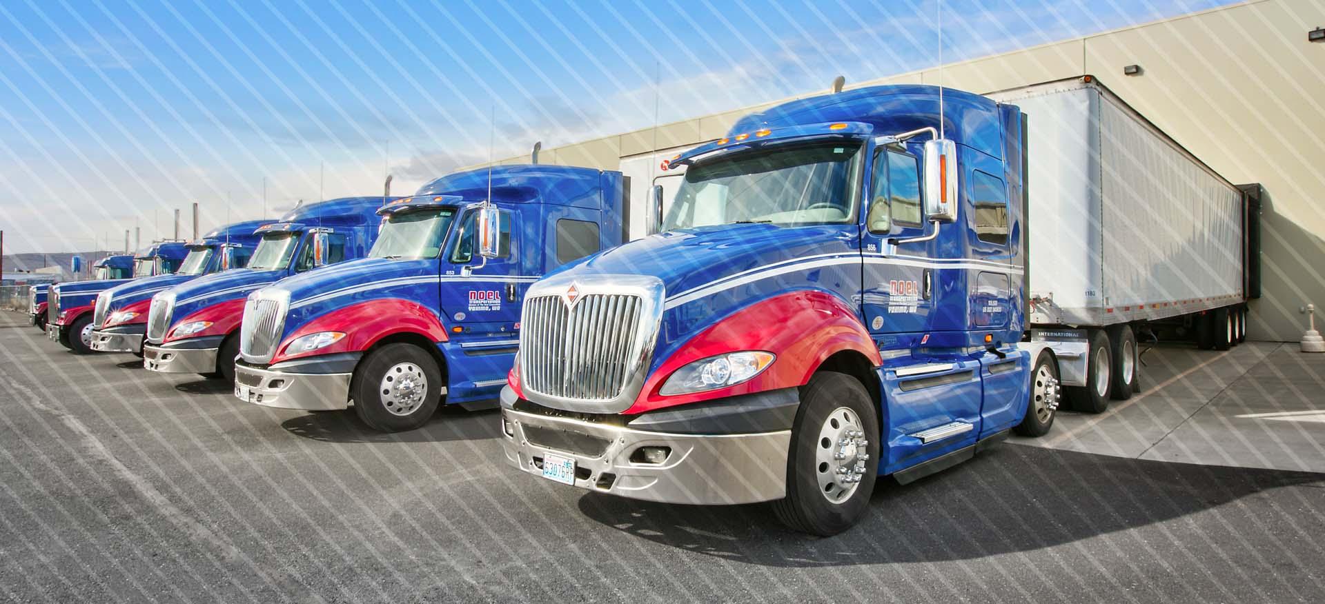 Blue and red semi-trucks parked in front of facility