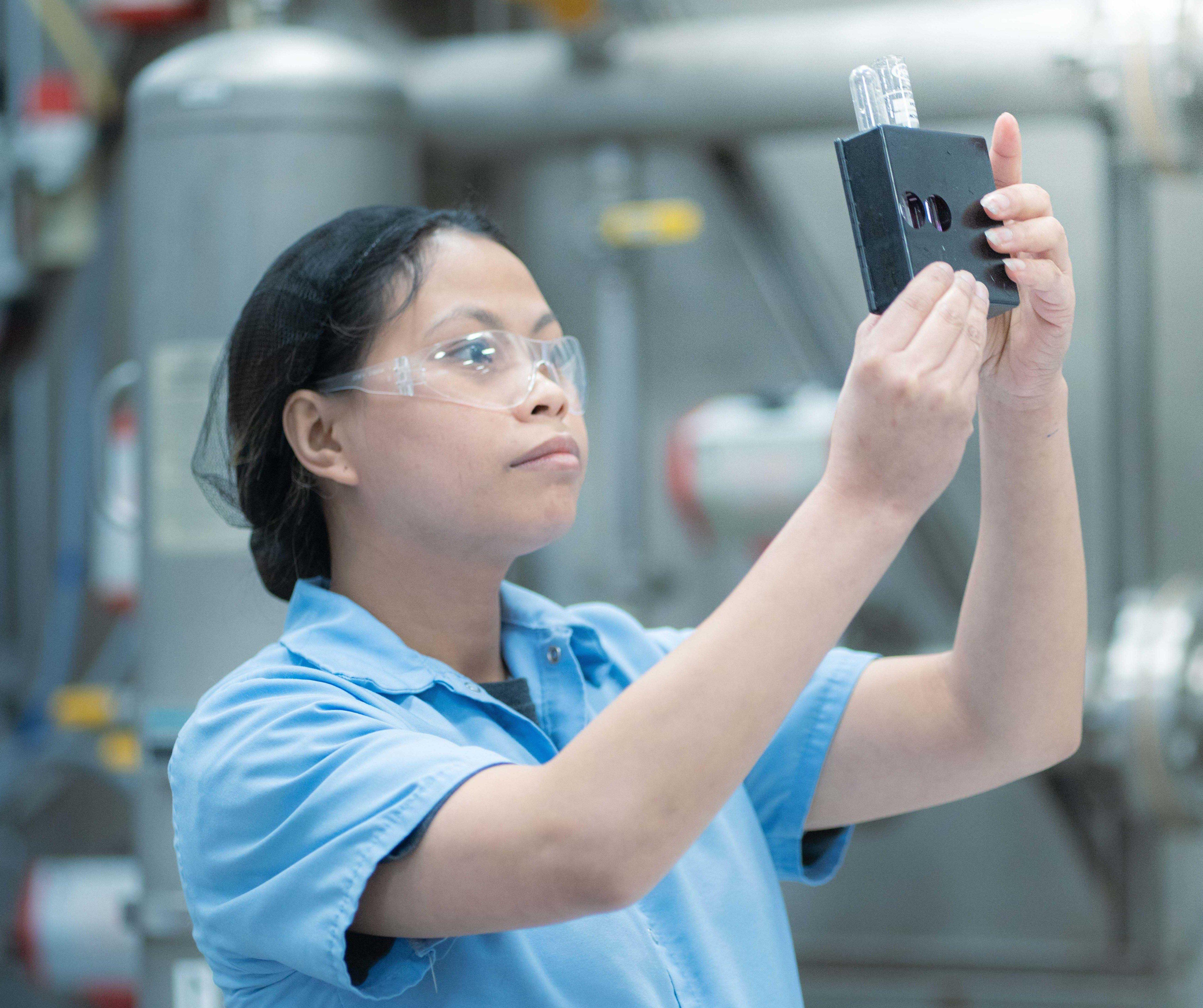 Person in laboratory inspecting product for quality assurance